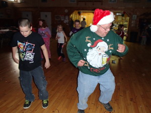 DJ Clyde gets right out there and with this little boy leads the Cupid Shuffle.